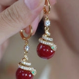 New red pearl green eye money snake ear buckle simple Year of the Snake earrings niche New Year long fringed earrings